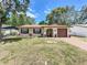 Charming single-story home with brown shutters, an arched entrance, and a well-maintained lawn at 2617 S Marshall Ave, Sanford, FL 32773