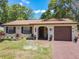 Charming, one-story home with a brick exterior, front lawn, and a driveway leading to an attached garage at 2617 S Marshall Ave, Sanford, FL 32773