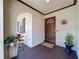 Covered front porch with brick archway and decorations like potted plant, and 'welcome home' doormat at 2617 S Marshall Ave, Sanford, FL 32773