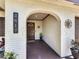 Covered front porch with brick archway, house number display, and decorated with potted plant at 2617 S Marshall Ave, Sanford, FL 32773