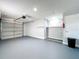 A clean, well-lit garage offers ample storage, with painted walls and concrete floor at 2617 S Marshall Ave, Sanford, FL 32773