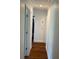 Hallway with hardwood floors, neutral walls, and doors leading to other rooms at 2617 S Marshall Ave, Sanford, FL 32773