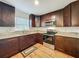 Well lit kitchen with dark cabinets, granite countertops and stainless steel appliances at 2617 S Marshall Ave, Sanford, FL 32773