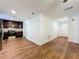 An open kitchen and living space with wood floors, dark cabinets and granite countertops offers a modern feel at 2617 S Marshall Ave, Sanford, FL 32773