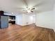 Open-concept living room showcasing wood-style vinyl floors, a ceiling fan, and direct view to kitchen at 2617 S Marshall Ave, Sanford, FL 32773