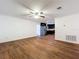 Living room features hardwood-style vinyl floors, with a ceiling fan, and direct view of the kitchen at 2617 S Marshall Ave, Sanford, FL 32773