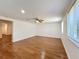 Spacious living room has hardwood floors, a ceiling fan, and neutral paint at 2617 S Marshall Ave, Sanford, FL 32773