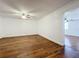 Neutral living room with hardwood-look vinyl floors, white walls, a ceiling fan, and view into second room at 2617 S Marshall Ave, Sanford, FL 32773