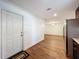 Open-concept living area with wood-look flooring and modern white walls at 2617 S Marshall Ave, Sanford, FL 32773