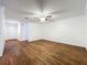 Neutral living room with hardwood-look vinyl flooring, white walls, ceiling fan, and entrance door on the left at 2617 S Marshall Ave, Sanford, FL 32773