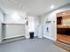 Clean utility room with water heater, storage shelves, and painted floor at 2617 S Marshall Ave, Sanford, FL 32773