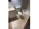Functional bathroom with a white vanity, toilet, and tiled shower/tub combo with tiled floor at 2618 Adela Ave, Orlando, FL 32826