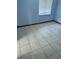 Cozy bedroom with a large window, tiled floors and neutral walls, offering a simple and comfortable space at 2618 Adela Ave, Orlando, FL 32826