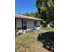 Modest single-story home featuring a simple facade and a small front yard under a blue sky at 2618 Adela Ave, Orlando, FL 32826