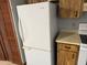 Kitchen featuring a white refrigerator and wooden cabinetry with white countertops at 2618 Adela Ave, Orlando, FL 32826
