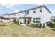 Backyard with patio and green lawn, surrounded by well-kept neighboring homes at 2865 High Pointe St, Clermont, FL 34711