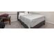 Comfortable bedroom with carpeted floors, a bed, and a side table at 2865 High Pointe St, Clermont, FL 34711