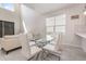 Dining area featuring modern glass table, white chairs, and access to bright living space at 2865 High Pointe St, Clermont, FL 34711