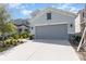 Charming home with a two-car garage, gray paint, stone accents, and well-maintained landscaping at 2865 High Pointe St, Clermont, FL 34711