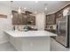 Modern kitchen featuring a large island, gray cabinets, stainless steel appliances, and pendant lighting at 2865 High Pointe St, Clermont, FL 34711