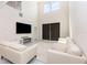 Bright, open living space with high ceilings, modern decor, and large windows provides ample natural light at 2865 High Pointe St, Clermont, FL 34711