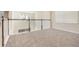 Open loft area with plush carpeting, a railing, and a window at 2865 High Pointe St, Clermont, FL 34711
