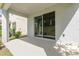 Covered outdoor patio with sliding glass doors offering a seamless transition to the backyard at 2865 High Pointe St, Clermont, FL 34711