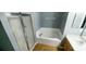 Bathroom featuring a soaking tub with glass enclosed shower and a vanity at 3131 Effingham Dr, Clermont, FL 34714