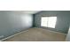 Empty bedroom with vaulted ceilings, neutral paint, carpeted floors and a large window for natural light at 3131 Effingham Dr, Clermont, FL 34714