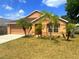 Charming single Gathering home with beautiful landscaping including palm trees and a two car garage at 3131 Effingham Dr, Clermont, FL 34714
