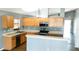 Functional kitchen with wood cabinetry, stainless steel appliances, and a breakfast bar for casual dining at 3131 Effingham Dr, Clermont, FL 34714