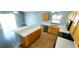 Modern kitchen featuring wood cabinets, quartz countertops, stainless steel appliances, and an adjacent breakfast bar at 3131 Effingham Dr, Clermont, FL 34714