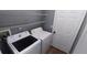 Functional laundry room equipped with a side-by-side washer and dryer and wire shelving for storage at 3131 Effingham Dr, Clermont, FL 34714
