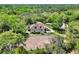 Aerial view of home with a sprawling paddock and a lush forest backdrop at 3149 Scrub Oak Trl, Oviedo, FL 32765
