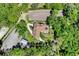 Aerial view of home, paddock, gardens, and the winding driveway amid a lush green, wooded setting at 3149 Scrub Oak Trl, Oviedo, FL 32765