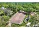 Aerial view shows paddock bordered by white fence and home nestled amid trees and green landscape at 3149 Scrub Oak Trl, Oviedo, FL 32765