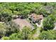 This is an aerial view showcasing a home with a horse paddock in a lush, green, wooded surrounding at 3149 Scrub Oak Trl, Oviedo, FL 32765