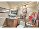 Bathroom with warm lighting, decorative mirror, flowers, and a white toilet at 3149 Scrub Oak Trl, Oviedo, FL 32765