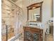 Bathroom vanity showcasing wood cabinet, decorative mirror, and a marble shower with stone floor at 3149 Scrub Oak Trl, Oviedo, FL 32765