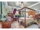 Primary bedroom featuring a canopy bed, desk, and elegant decor at 3149 Scrub Oak Trl, Oviedo, FL 32765