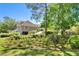 Charming home with manicured garden, lush greenery, and a long driveway at 3149 Scrub Oak Trl, Oviedo, FL 32765