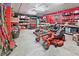 Garage with tools and lawnmower, red walls, and overhead lighting at 3149 Scrub Oak Trl, Oviedo, FL 32765