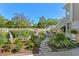 Beautiful landscaping with a statue, walking paths, and mature plants and shrubbery at 3149 Scrub Oak Trl, Oviedo, FL 32765