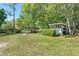 Expansive grassy area with well-maintained landscaping and outbuildings, perfect for outdoor activities at 3149 Scrub Oak Trl, Oviedo, FL 32765