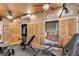 Home gym with bi-fold doors to closets featuring exercise equipment, weights, and multiple ceiling fans at 3149 Scrub Oak Trl, Oviedo, FL 32765