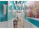Elegant hallway featuring a chandelier and decorative wall trim at 3149 Scrub Oak Trl, Oviedo, FL 32765