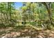 Gated entrance with a 'Welcome' sign, framed by mature trees and greenery, creating a warm invitation at 3149 Scrub Oak Trl, Oviedo, FL 32765