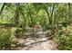 View of the tree-lined driveway leading to a gated entrance, offering privacy and seclusion at 3149 Scrub Oak Trl, Oviedo, FL 32765