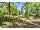 View of the gated entrance, surrounded by lush landscaping and mature trees, providing a private setting at 3149 Scrub Oak Trl, Oviedo, FL 32765