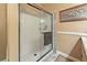 Modern shower with white tiled walls, glass door, built-in shelves, and a towel bar at 3149 Scrub Oak Trl, Oviedo, FL 32765